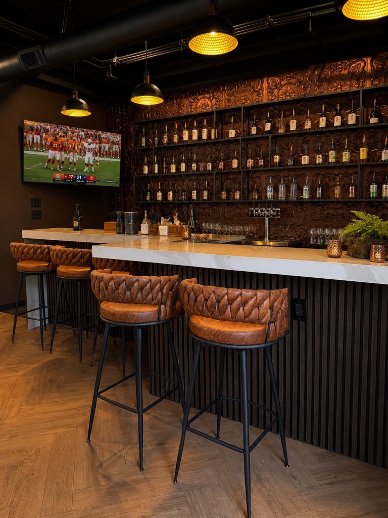 The Birdie House VIP lounge with big-screen sports wall